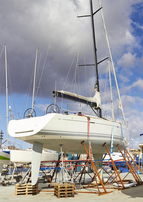 Barnacles can be removed from a boat's hull when it is laid up, though fiberglass surfaces should be gently scraped.