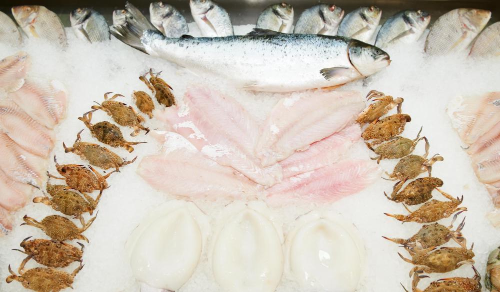 The dimunitive oyster crab is often served as a delicacy alongside other seafood offerings.