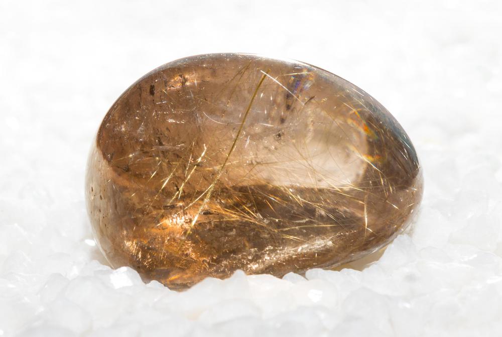 The rutile enclosures appears as long thin lines through the quartz.