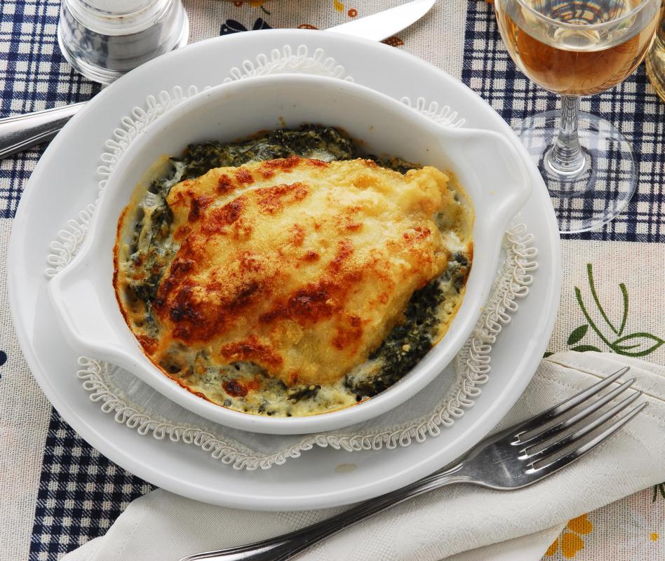 Scrod baked with vegetables and a creamy sauce.