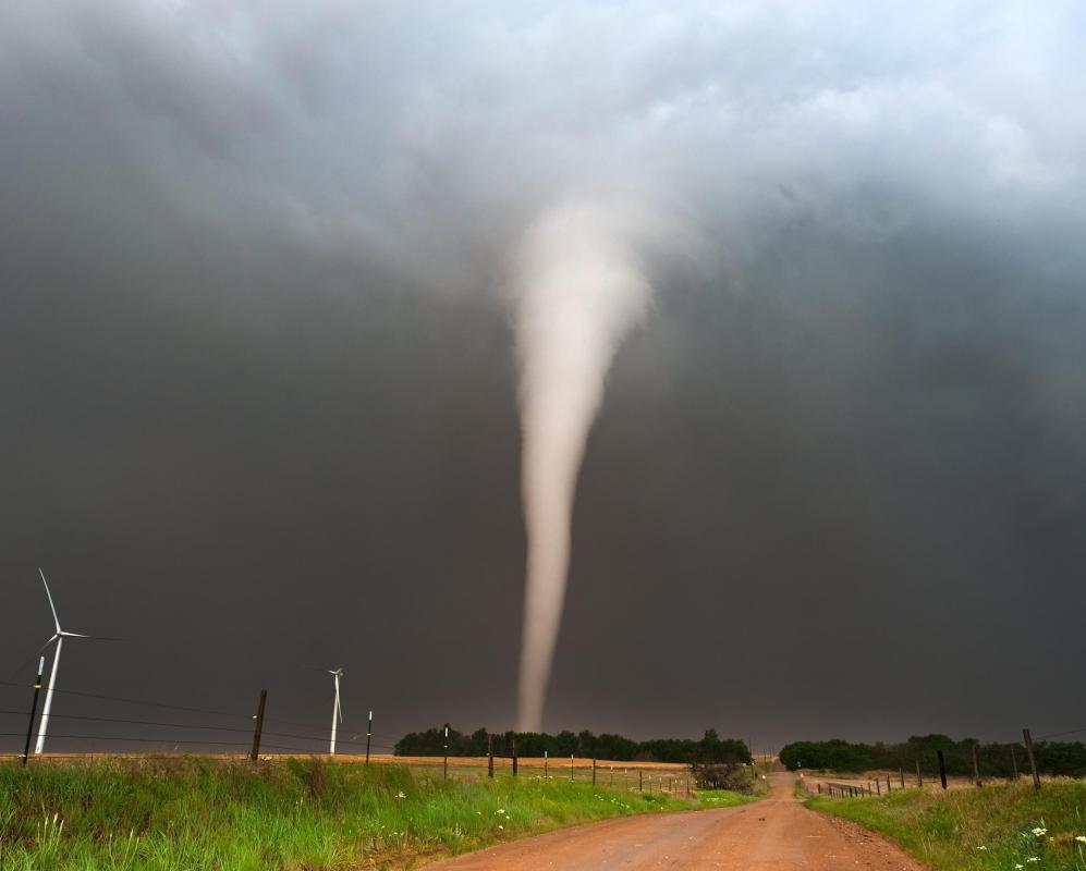 A tornado appears as a funnel shape in the sky.