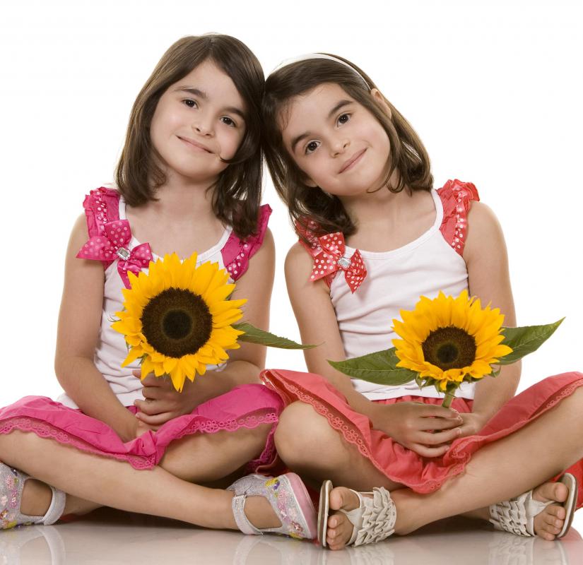 Girls holding sunflowers.