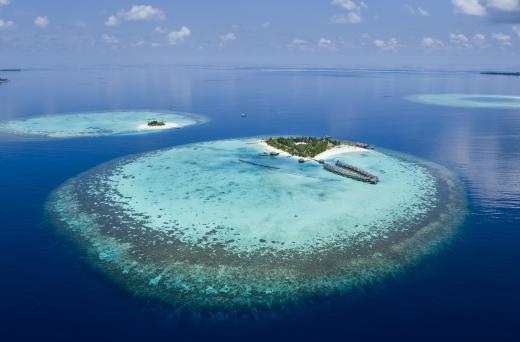 An atoll generally circles a lagoon that may have developed due to the sinking of a volcanic island.