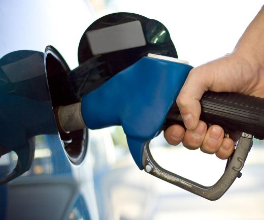 A man filling up his gas tank. Gasoline-powered cars release carbon dioxide into the atmosphere.